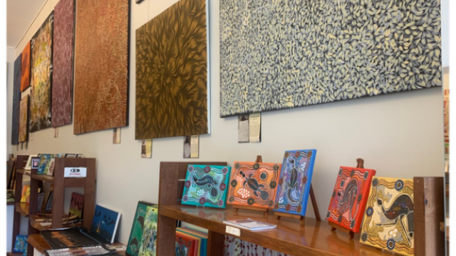 An art gallery with many examples of paintings by indigenous artists.