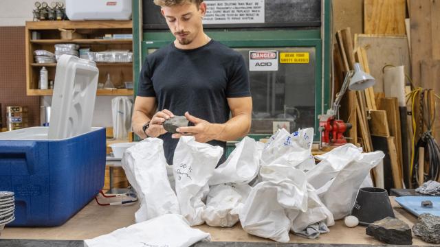 Image of Geo with geologic sampling bags.