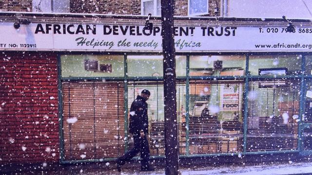  Johny Pitts’s black-and-white photograph African Development, Finsbury Park (2010), showing a person standing outside the African Development Trust storefront in London, displayed as part of the artist’s Black Bricolage exhibition at the Maison Européenne de la Photographie in Paris.