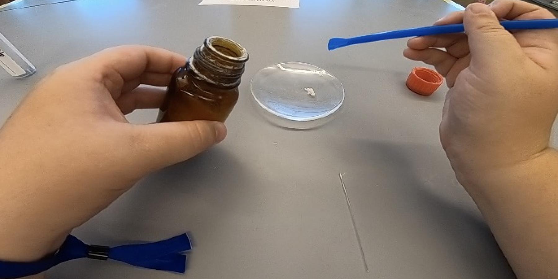 a snapshot taken from one of my videos. In this particular snapshot, I am measuring out some of my sample solid. Shows how the videos are taken from the perspective of the student.