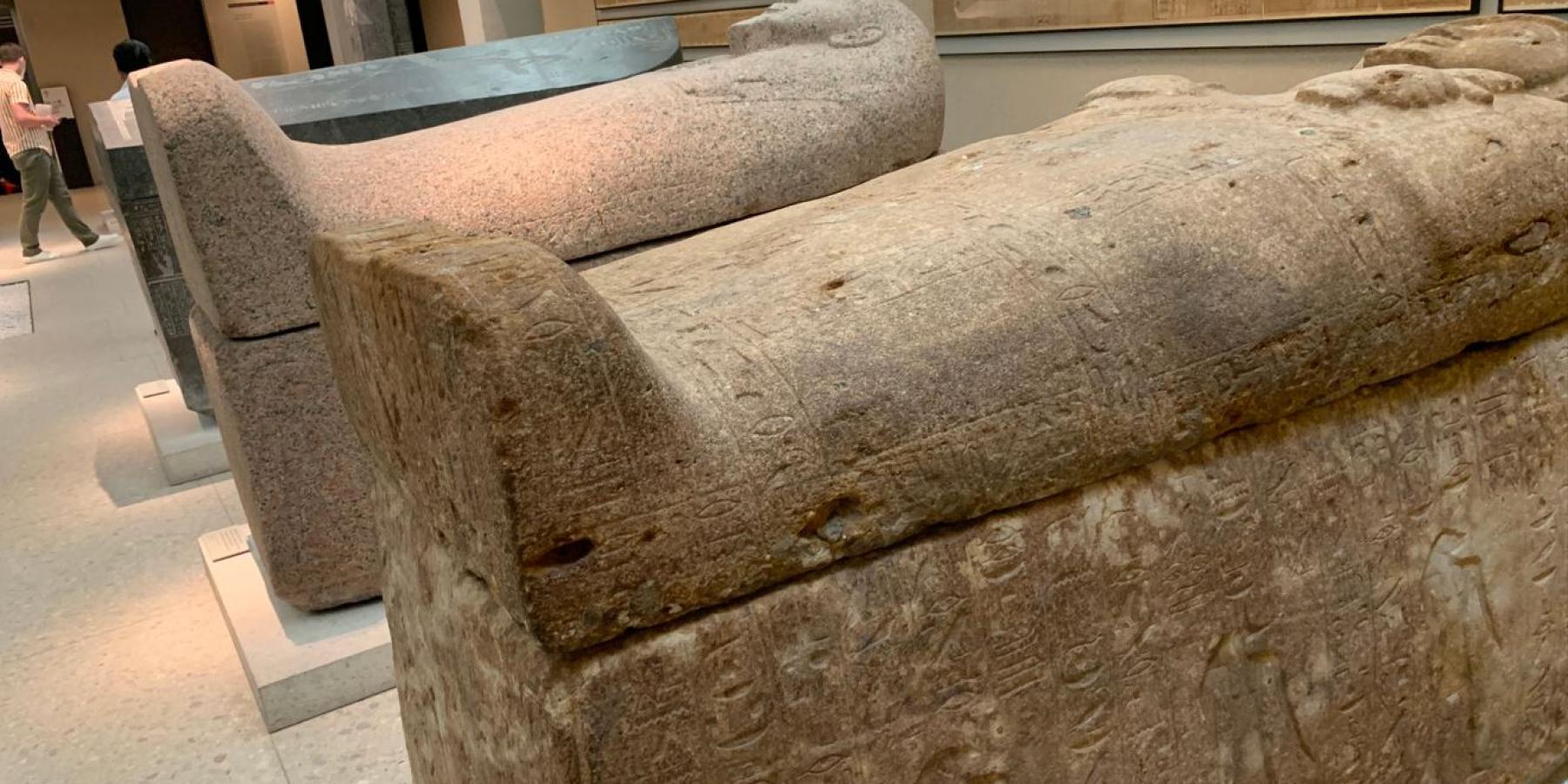 Two stone tombs in a museum.