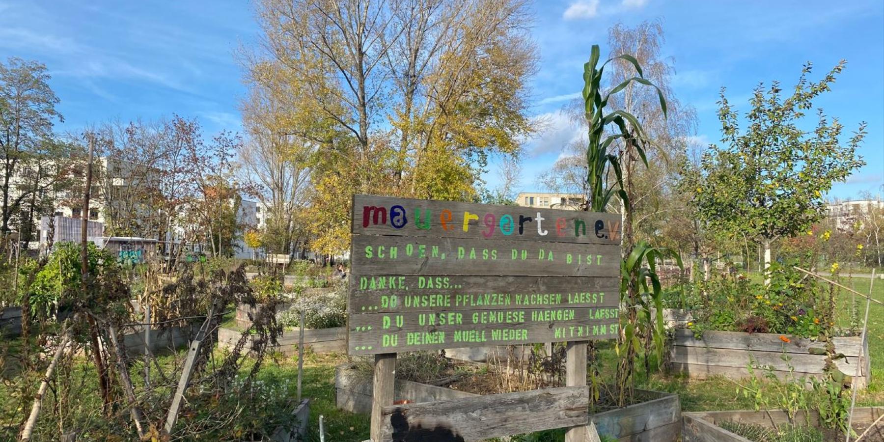 A hand-painted sign in German detailing rules for visiting the garden.
