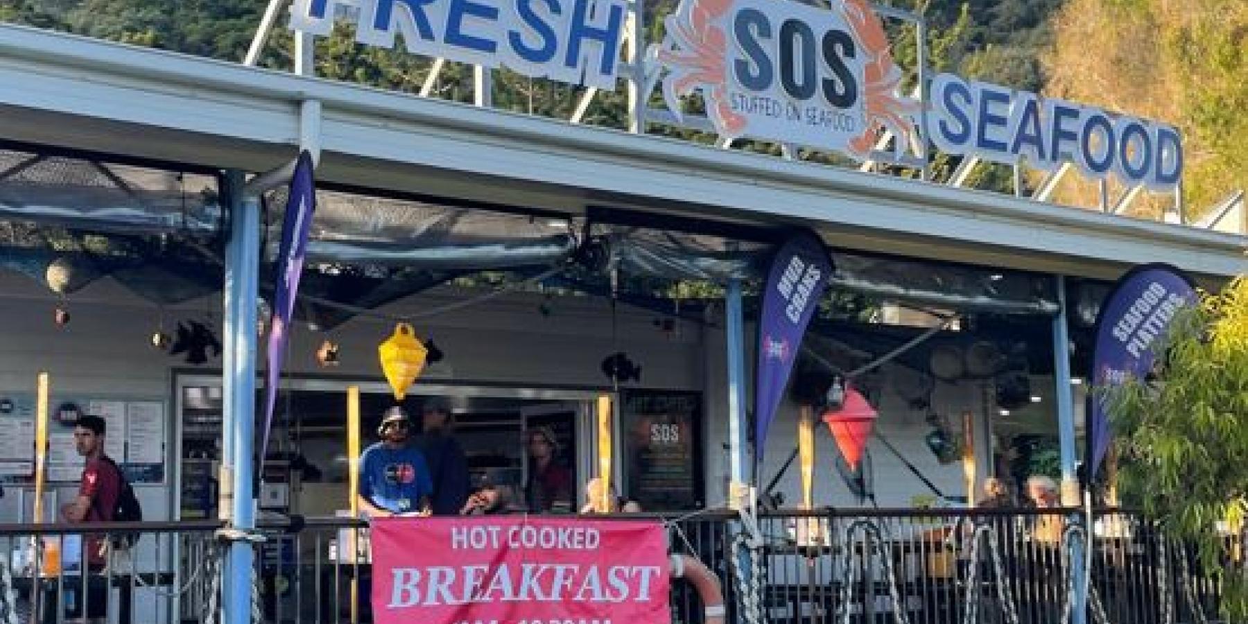 A restaurant advertising fresh seafood.