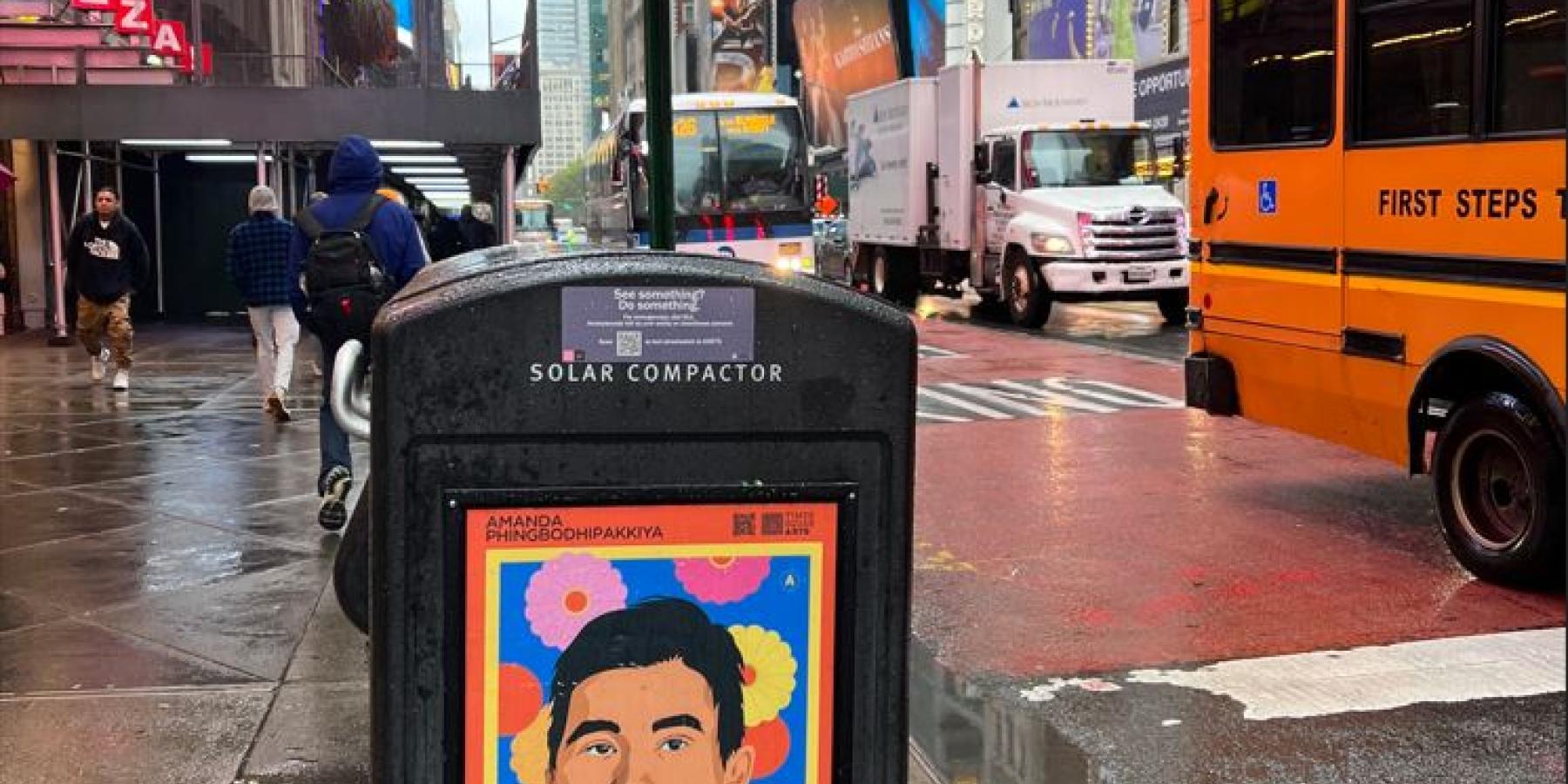 A poster on the side of a trash can stating &amp;quot;Stand with Us.&amp;quot;