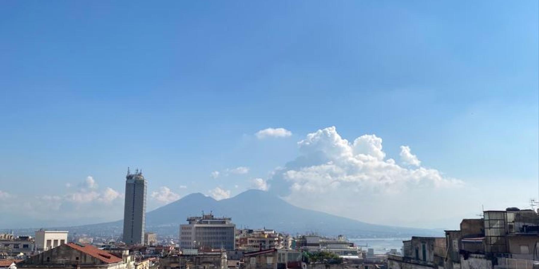 Yellow buildings with mountains in the background.
