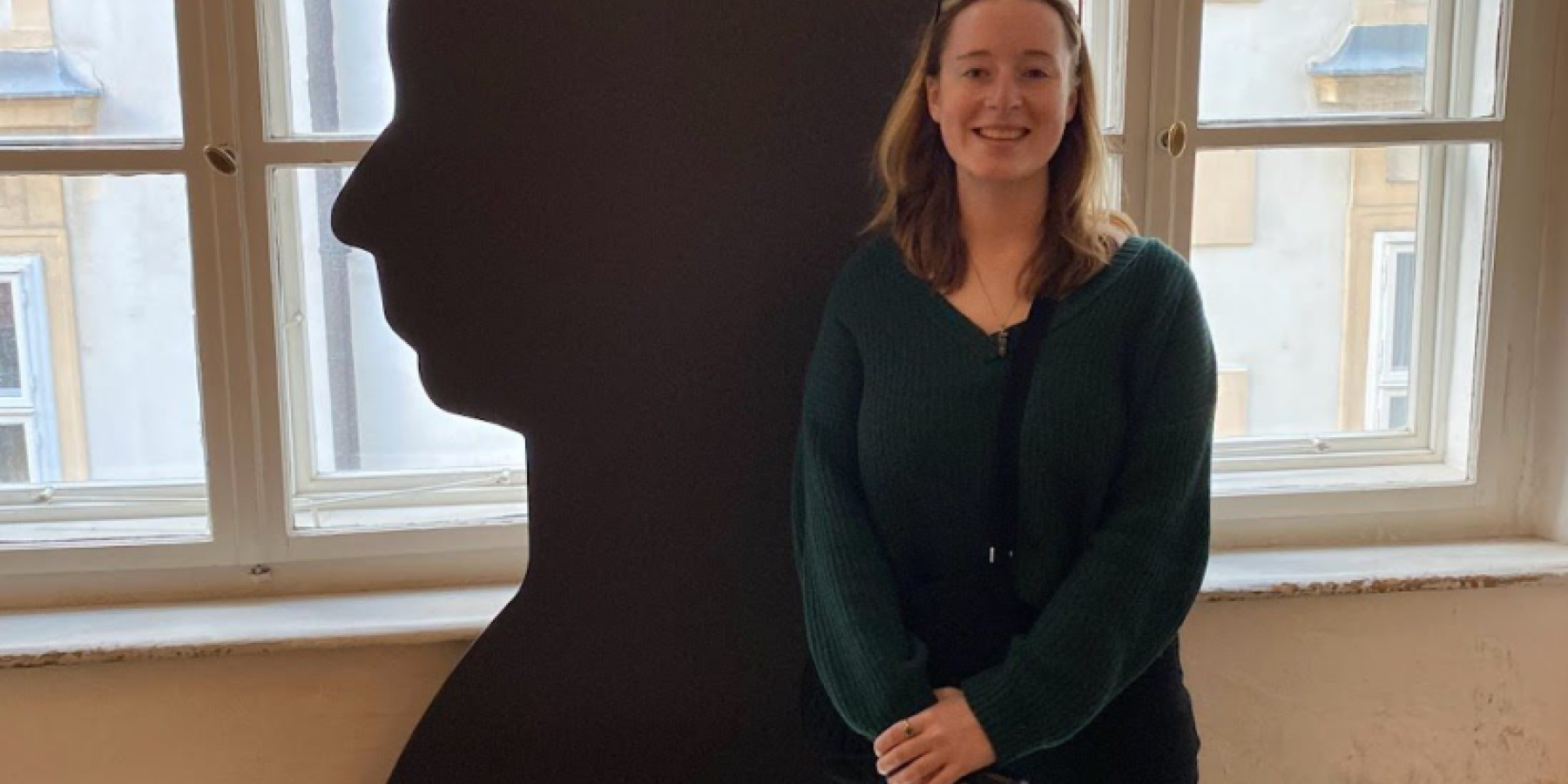 Morgan stands next to a silhouette of Mozart.