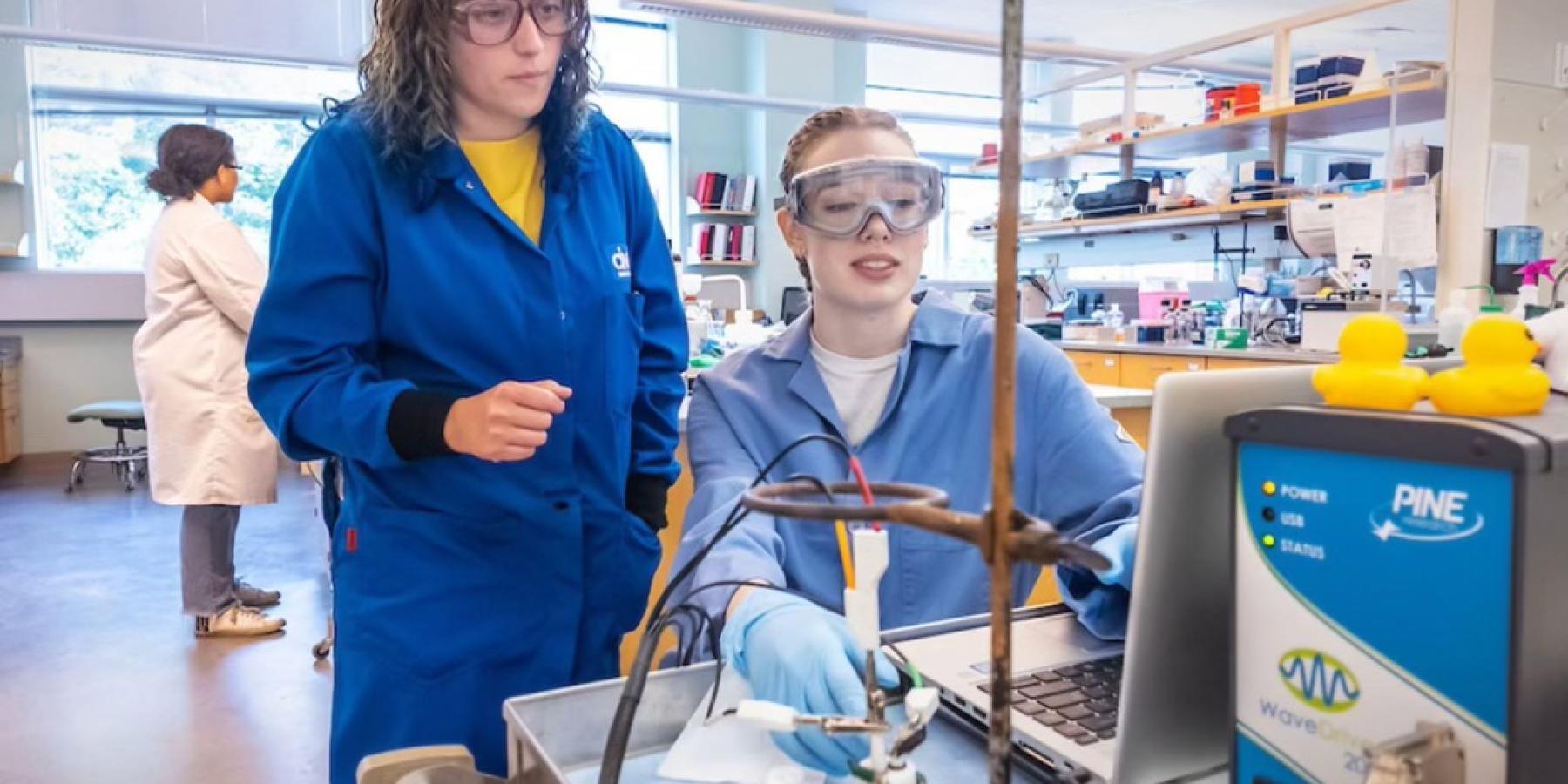 Student examining results with advisor