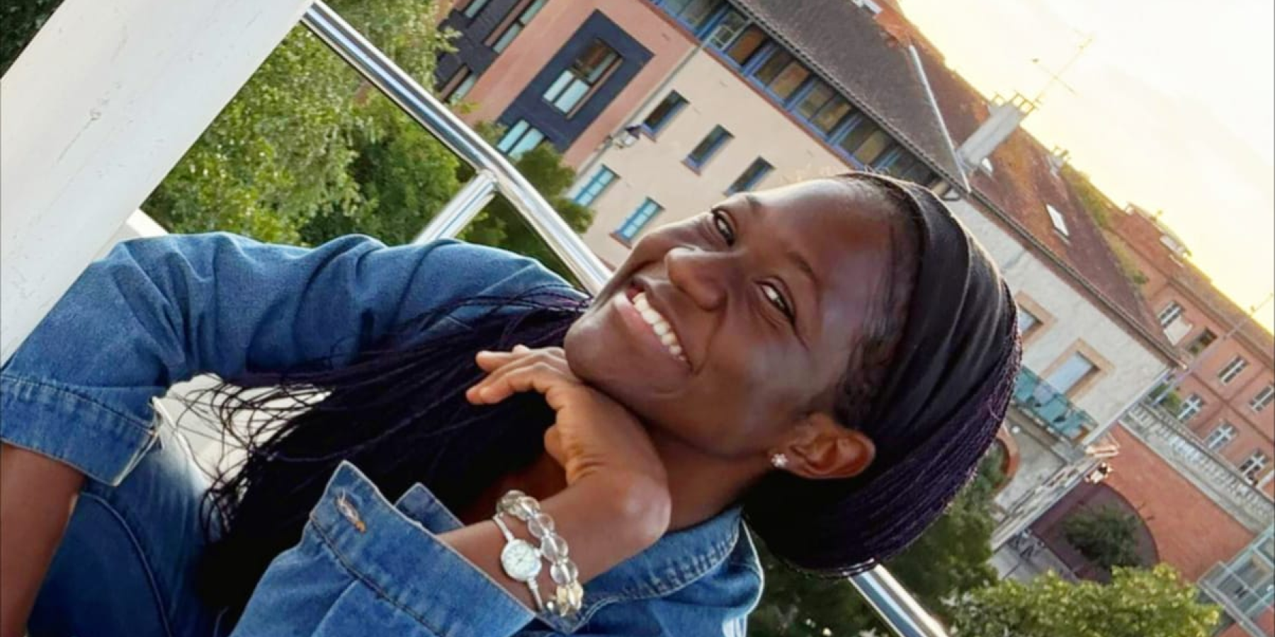 A smiling person poses on a ferris wheel with the Chapelle de La Grave in the background