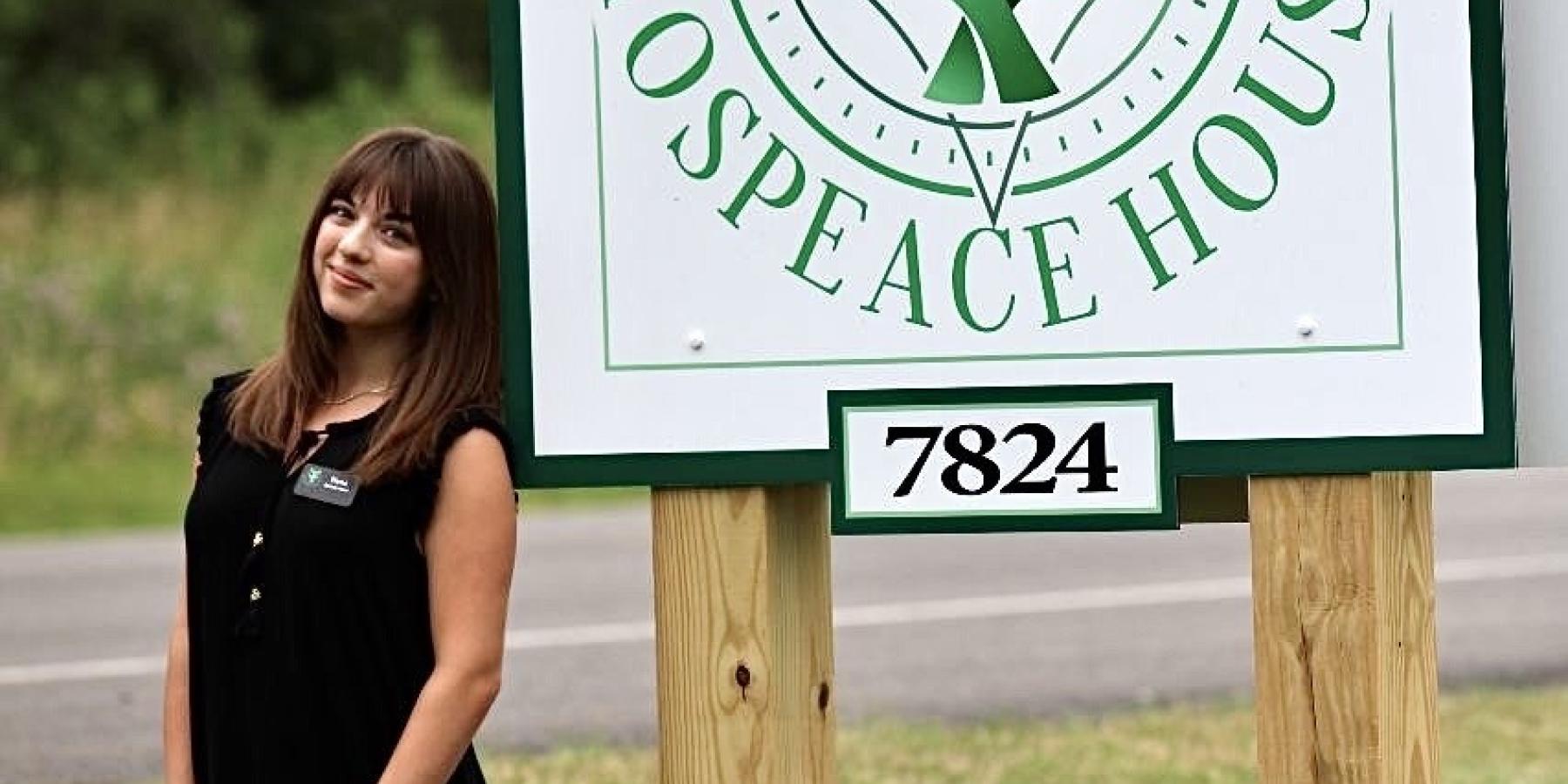 Student Intern, Elena Dickinson, shown in front of Hospeace House sign in Naples, NY.