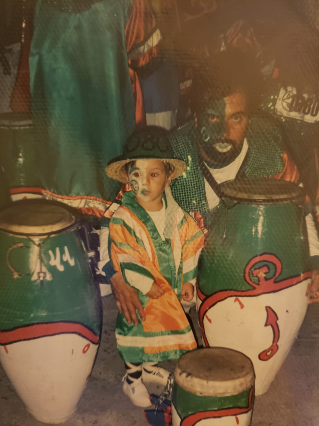 kid with adult and set of drums