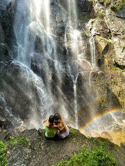 waterfall with two people in foreground