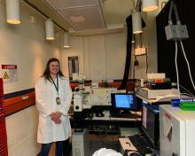 Cora Ferguson standing in the biophotonics lab at Vanderbilt
