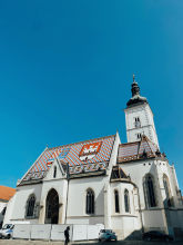 Photo of a church with an ornate tile roof.