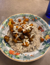 A white and orange plate with food on it.