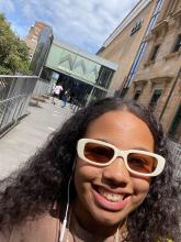 Luisa takes a selfie while walking out of a museum.