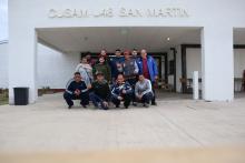 group of people posing against sign CUSAM U48 SAN MARTIN