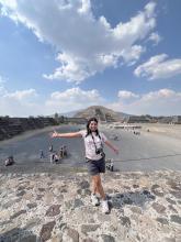 a picture of berenice in front of front of the tenochtitlan moon pyramid 