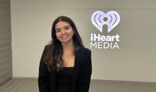  iHeartMedia headquarters, standing in front of the illuminated company logo after completing my summer internship with the Product Data Analytics team.