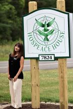 Student Intern, Elena Dickinson, shown in front of Hospeace House sign in Naples, NY. 