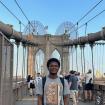 A photo of me standing on the Brooklyn bridge.