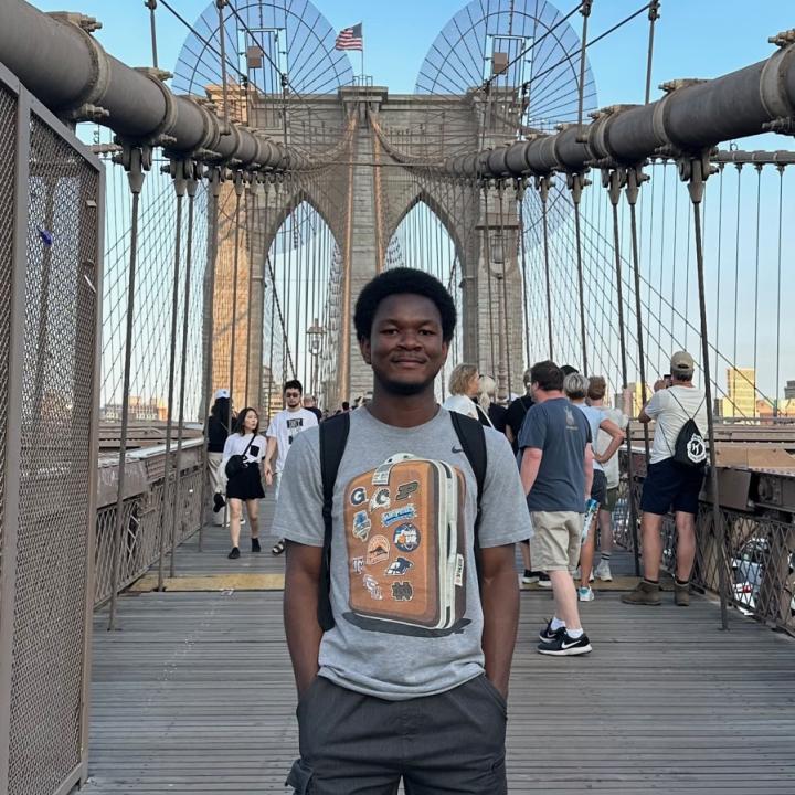 A photo of me standing on the Brooklyn bridge.
