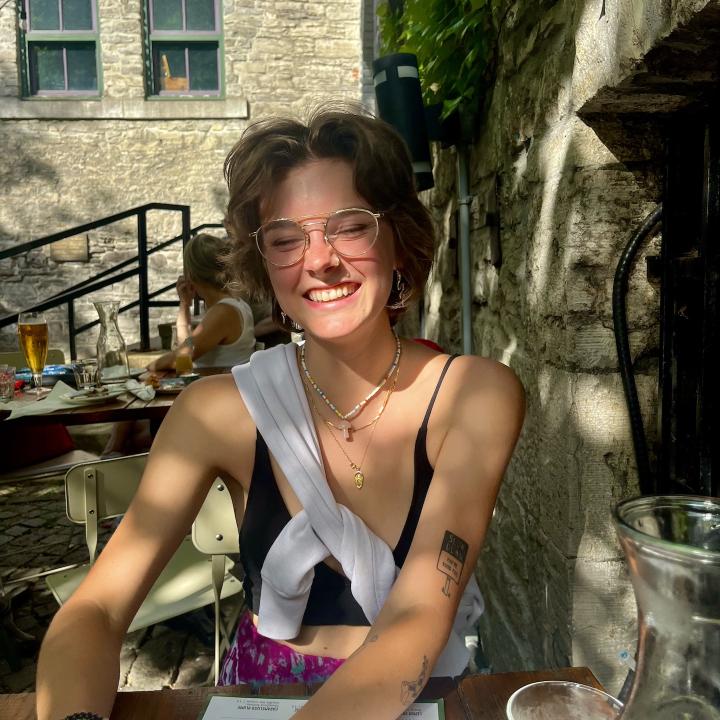 Photo of Molly seated, smiling at the camera.