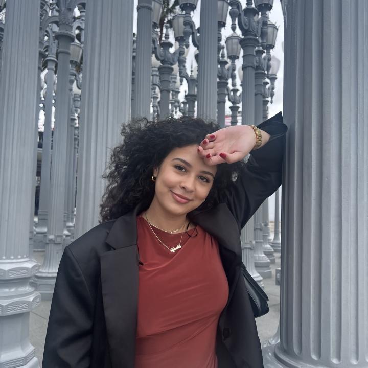 Girl standing in front of a pole
