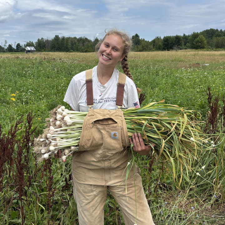 Berit holding garlic that she harvested!