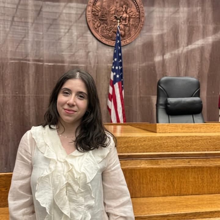 The picture is taken at the Superior Court of Los Angeles county and displays the judges seat with a flag of United States of America.