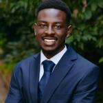 Headshot of Shaun Kithinji. Blue Suit and Tie. 