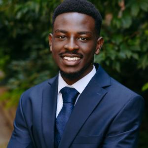 Headshot of Shaun Kithinji. Blue Suit and Tie. 
