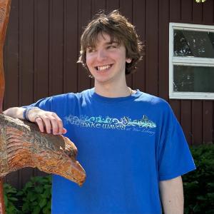 An image of me smiling in a blue t-shirt